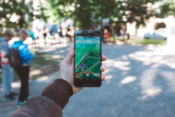 A phone playing Pokemon Go in a park