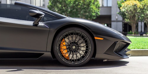 A Lamborghini's front wheel and panel in profile