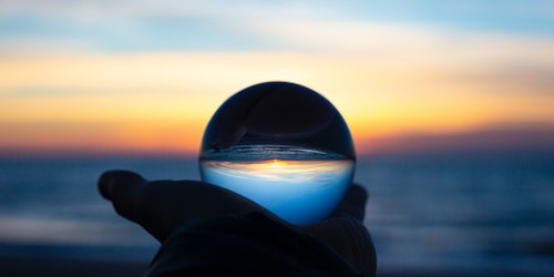 A crystal ball, in a human hand