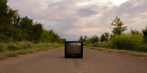 A TV in the middle of an otherwise-empty road