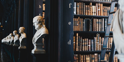An old library with busts of Greek scholars