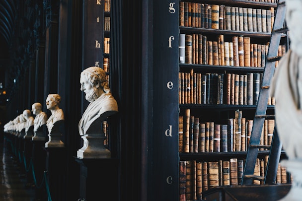 An old library with busts of Greek scholars
