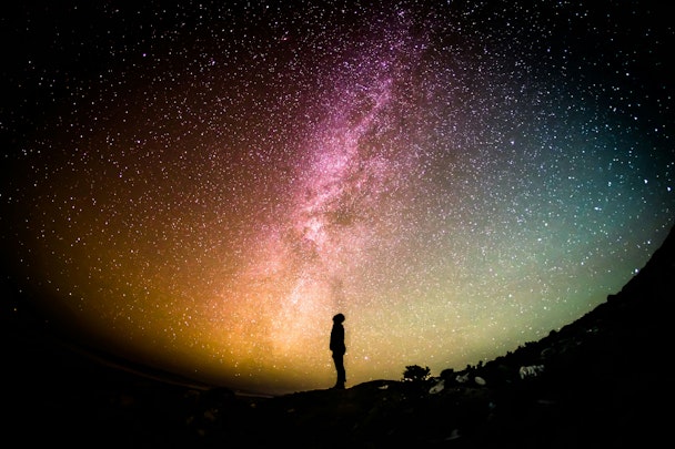 A person standing in front of a field of stars