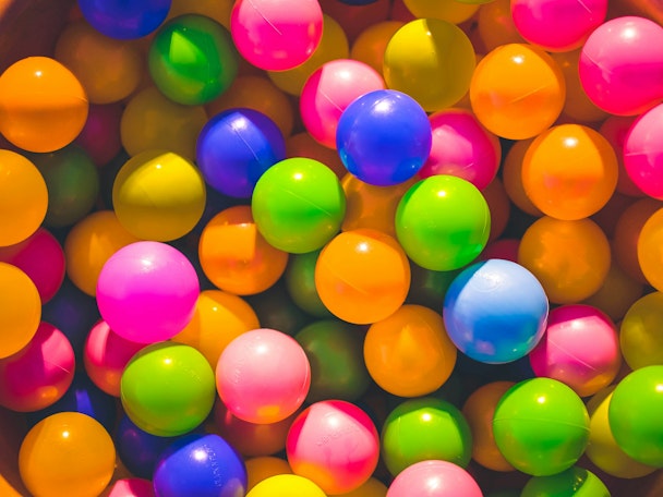 Brightly colored balls, as in a ball pit