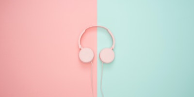 A pair of headphones on a split-color background
