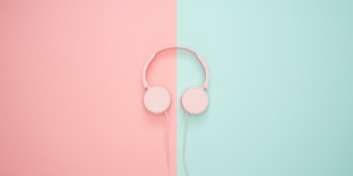 A pair of headphones on a split-color background