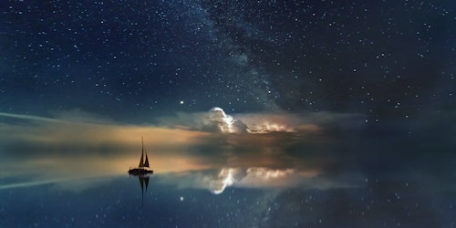 A sail boat at sea, among reflected stars
