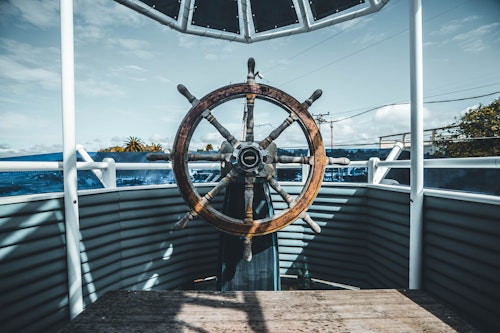 A ship's old-fashioned wooden steering wheel