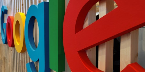 Google's logo on a wall of an office building, up close