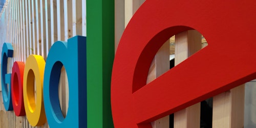 Google's logo on a wall of an office building, up close