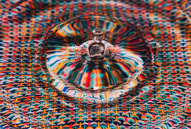 A drop of water against a colorful background