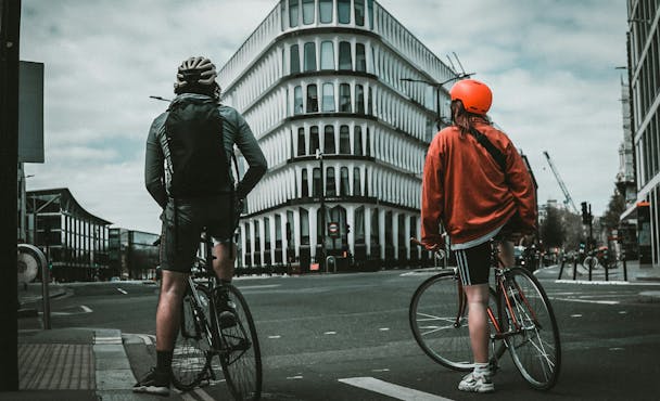 Two cyclists approaching a split in the road Two cyclists approaching a split in the road