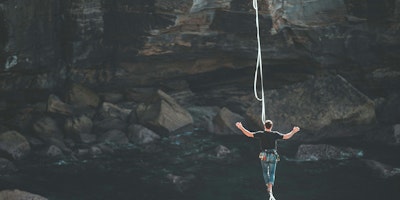 A tightrope walker over a vast chasm