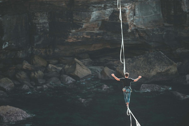 A tightrope walker over a vast chasm