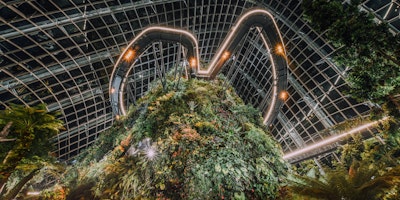 A large pyramid made up of plants, surrounded by futuristic lighting