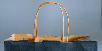 The top and twine handle of a blue paper bag