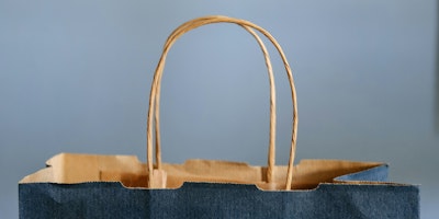 The top and twine handle of a blue paper bag