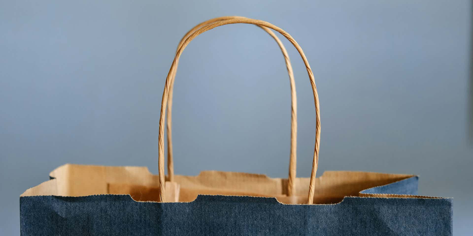 The top and twine handle of a blue paper bag