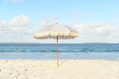 A beach umbrella, on a beach