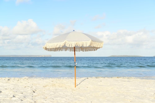 A beach umbrella, on a beach