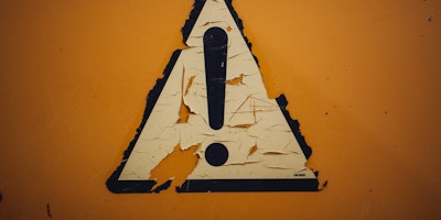 A peeling triangular sign featuring an exclamation mark!