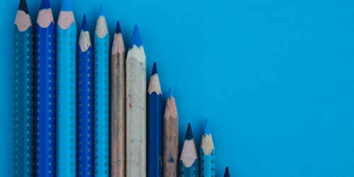 A number of blue pencils standing upright
