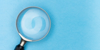 A magnifying glass against a blue background