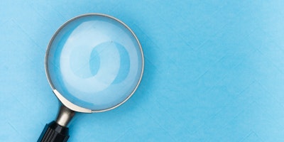 A magnifying glass against a blue background