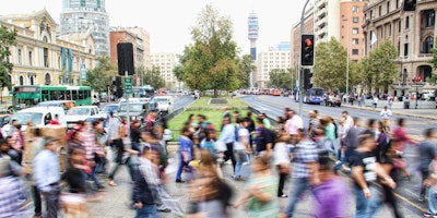 A blur of people walking across an intersection