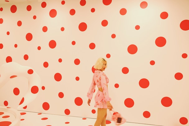 A woman at a Yayoi Kusama red-and-white polkadot exhibition