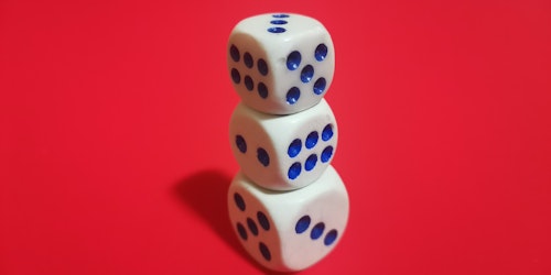 A stack of blue and white dice on a red background