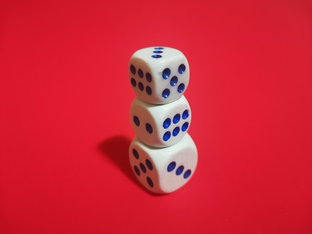 A stack of blue and white dice on a red background