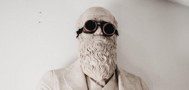 A marble bust of Charles Darwin, wearing steampunk eye goggles