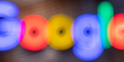 The Google logo, zoomed in and blurry