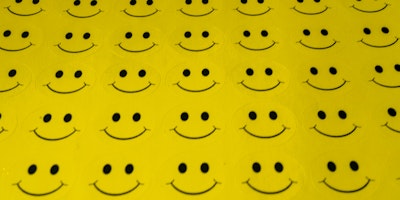 A sheet of unpeeled smiley face stickers