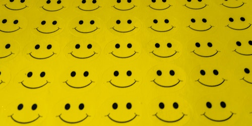 A sheet of unpeeled smiley face stickers