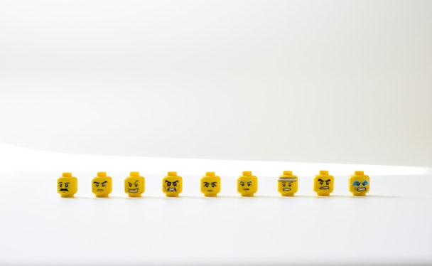 A row of Lego heads with angry expressions on their faces