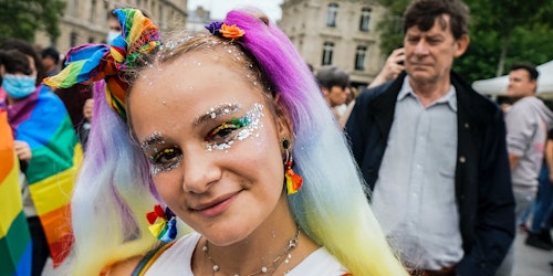 A brightly-dressed person at a Pride march