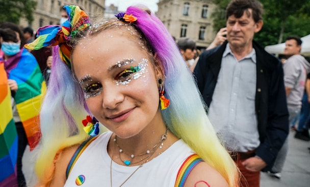 A brightly-dressed person at a Pride march