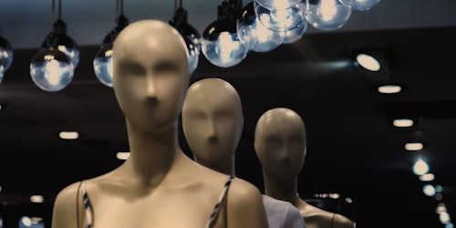Three faceless mannequins