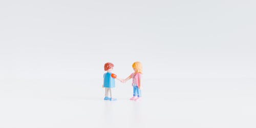 Two Lego figurines shaking hands Two Lego figurines shaking hands