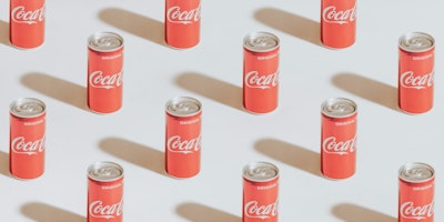 A geometric grid of Coca-Cola cans