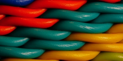 A close-up of multi-colored fibers in a piece of fabric