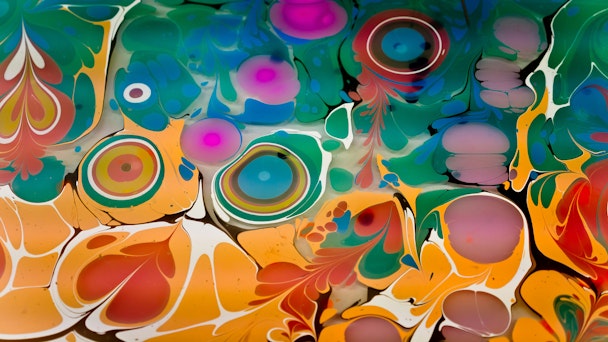 Swirls of colourful paint in a kaleidoscopic pattern