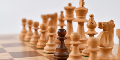 A chess board, with a 'black' pawn on the 'white' side