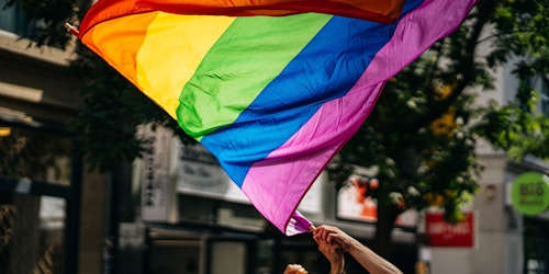 A rainbow pride flag at a parade