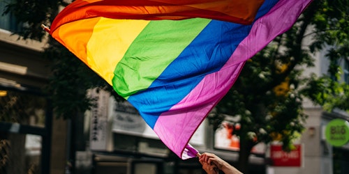 A rainbow pride flag at a parade