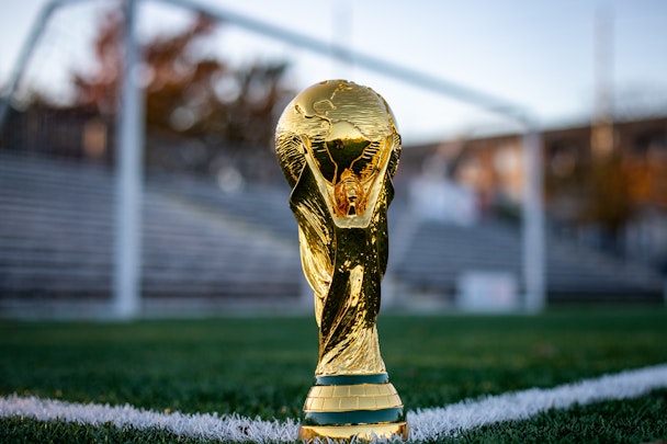 The Fifa World Cup Trophy on a soccer pitch