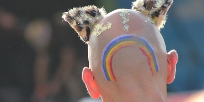 Someone with a a rainbow tattoo and shaved head