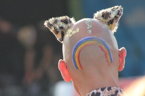 Someone with a a rainbow tattoo and shaved head